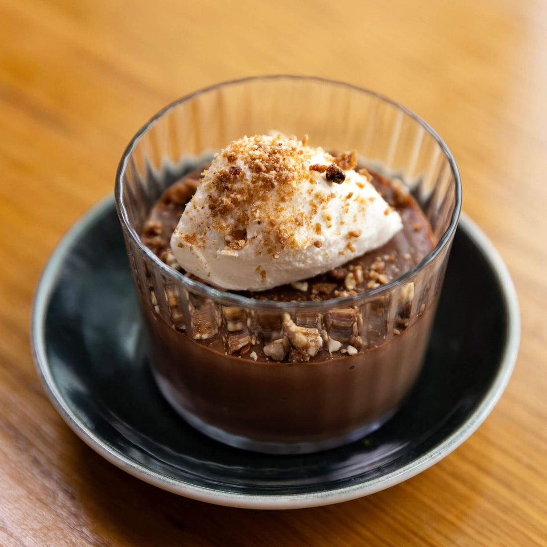 Chocolate budino made with Bibamba milk chocolate, topped with caramel chantilly and hazelnut brittle at Restaurant Olivia in Denver