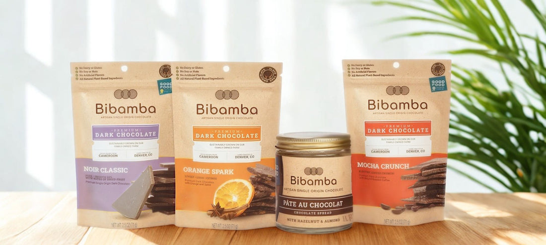 Bibamba chocolate products on a wooden surface with a blurred plant background