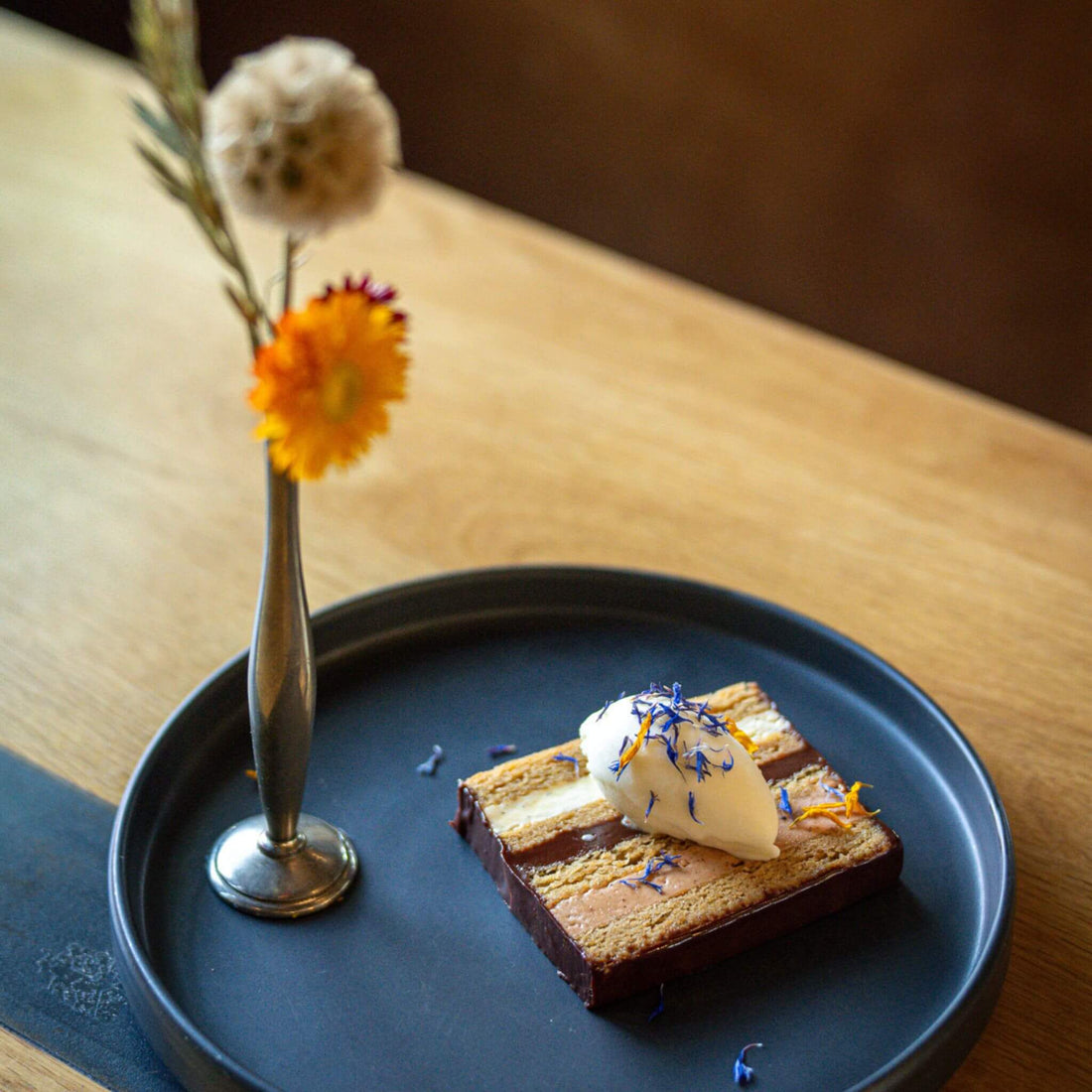 Photo by Jeff Fierberg. Wolfs Tailor dessert: Corn Pinole cake, Bibamba cocoa nib praline, Bibamba ganache, and vanilla buttercream. Paired with a fior di latte gelato. 