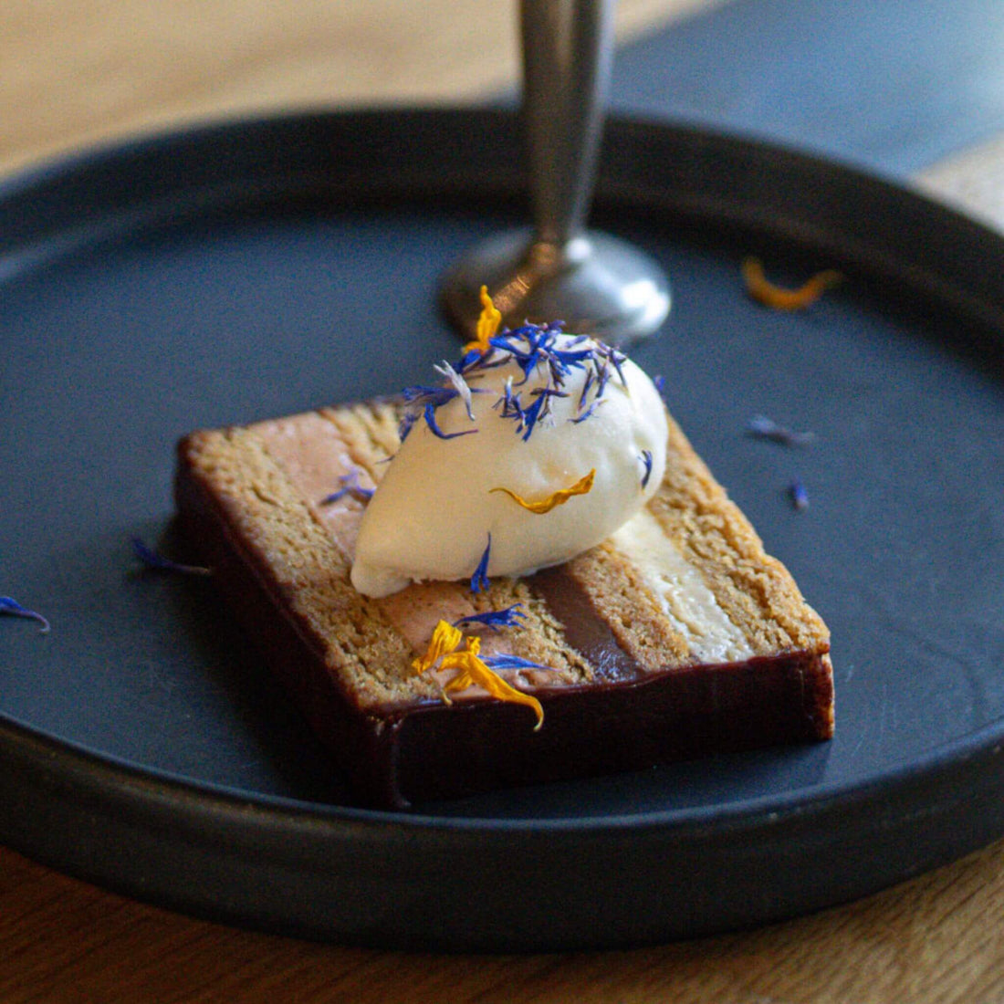 Photo by Jeff Fierberg. Wolfs Tailor dessert: Corn Pinole cake, Bibamba cocoa nib praline, Bibamba ganache, and vanilla buttercream. Paired with a fior di latte gelato. 